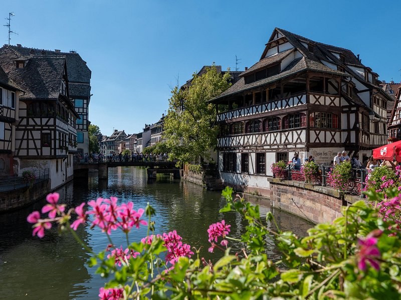 A tall half-timbered house in Strasbourg's Petite France seen from the water